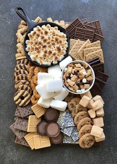 a tray filled with lots of different types of desserts and crackers on top of it