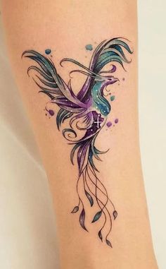 a colorful tattoo on the leg of a woman's leg with watercolors