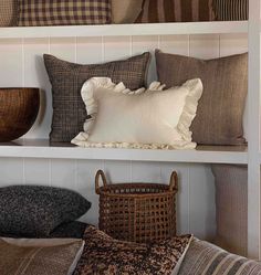 pillows and baskets on shelves in a room