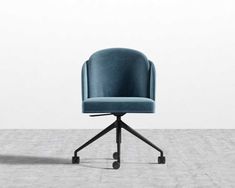 a blue chair sitting on top of a wooden table next to a white wall and floor