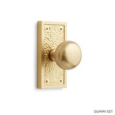 an image of a brass door knob on a white background with the word dummy set