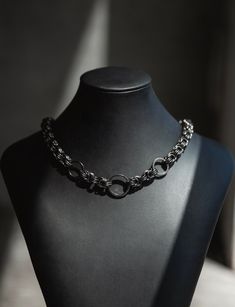 Discover the allure of unique craftsmanship with this handmade chainmail necklace, crafted from durable gunmetal-colored stainless steel. Each link is meticulously woven by hand, ensuring a one-of-a-kind piece that stands out. The necklace features an adjustable lobster clasp for a comfortable fit, making it perfect for those who appreciate alternative and distinctive jewelry styles. Handcrafted by an independent artist, this chainmail necklace blends durability with artistic flair. It's ideal f Black Stainless Steel Chainmail Jewelry, Elegant Black Chainmail Jewelry, Gunmetal Chain Link Jewelry, Black Metal Chainmail Necklace, Black Stainless Steel Necklaces With Chunky Chain, Black Chunky Chain Necklace In Stainless Steel, Metal Chain Link Necklace With Oxidized Finish, Gunmetal Link Chain Necklaces, Gunmetal Link Chain Necklace