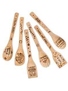 six wooden spoons with different designs and names are lined up on a white surface