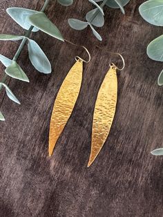 "Inspired from the olive leaves, for the strength that they show throughout the seasons and their delicate shape, offering their natural beauty effortlessly.  Olive leaves have been used as a symbol of win, overcoming obstacles and new beginnings for centuries. These beautiful leaf earrings are hand forged and hammered to shimmer and sparkle!  Keep the eyes on you with these minimal yet statement earrings! Totally lightweight perfect for everyday wear. Wear them with your dress or with your jean Nature-inspired Hammered Earrings As Gift, Leaf-shaped Brass Earrings With Ear Wire, Leaf Earrings Gold, Pebble Pendant, Cube Necklace, Overcoming Obstacles, Gold Leaf Earrings, Hammered Earrings, Gold Dangle Earrings