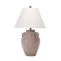 a table lamp with a white shade on it's base and a light bulb in the shape of a urn