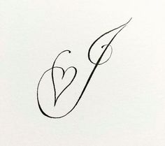 the letter v is made up of black ink and has a small heart on it