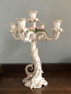 an ornate white candelabra on a wooden table