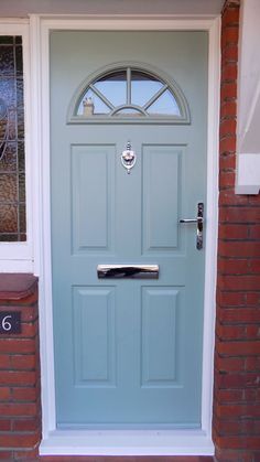 a blue front door on a brick house