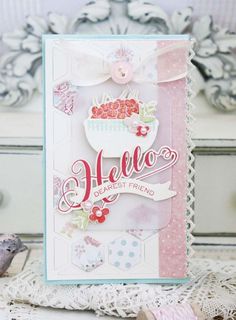 a card that says hello on it and has flowers in the center with a bow