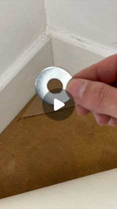 a hand pointing at a hole in the ceiling