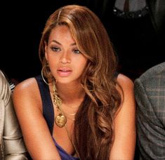 a close up of a person sitting at a table with a cell phone in her hand