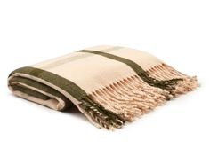 a green and white plaid blanket folded on top of a white surface with fringes