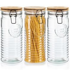 three glass jars with pasta noodles in them