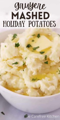 mashed potatoes in a white bowl with parsley on top and the words gluyere mashed holiday potatoes above it