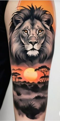 a man's arm with a lion tattoo on it and the sun in the background