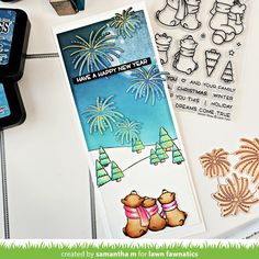 stamping supplies are laying on top of a table with stamps and other items to make new year's cards