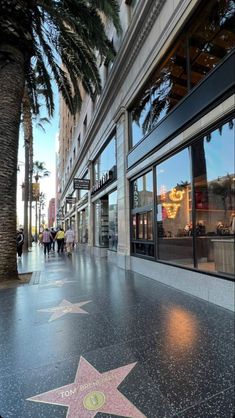 the hollywood walk of fame star is shown in front of an office building with palm trees