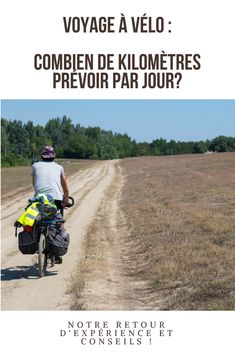 a man riding a bike down a dirt road