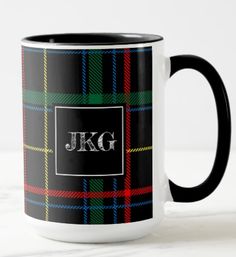 a black and green plaid mug with the initials jkg