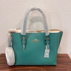 Color Green Vanilla Cream Double Face Leather Zip-Top Closure, Fabric Lining Side Open Compartments Handles With 4 3/4" Drop Detachable Strap With 22" Drop For Shoulder Or Crossbody Wear 9 3/4" (L) X 7 1/2" (H) X 4 3/4" (W) Style No. C4084 Green Tote Bags, Coach Mollie Tote, Coach Travel Bag, Coach Mollie, Coach Zip Top Tote, Paw Wallpaper, Coach Purses Outlet, Canvas Leather Tote Bag, Leopard Tote