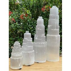 five plastic bottles sitting on top of a wooden table