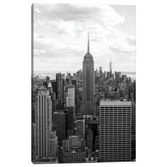 black and white photograph of the empire building in new york city, from top of the rock