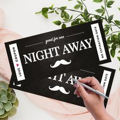 someone is writing on the ticket for their wedding night with a pair of scissors next to it