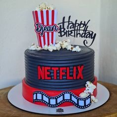 a birthday cake decorated with popcorn and the words happy birthday netflix on top of it