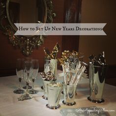 a table topped with lots of silver cups and glasses