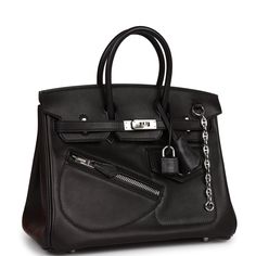 This Limited Edition Birkin is in black volupto leather with palladium hardware and has tonal stitching, various exterior pockets, front flap, two straps with center toggle closure, clochette with lock and two keys, and double rolled handles. The interior is lined with black swift and has one zip pocket with an Hermes engraved zipper pull and an open pocket on the opposite side.Collection: BOrigin: FranceCondition: New and never worn (Plastic on hardware)Accompanied by: Hermes box, Hermes dustba Black Hermes Bag, Hermes Limited Edition, Anarchy Symbol, Hermes Box, Birkin 25, Black Pride, Hermes Bags, Diaper Backpack, Sierra Leone