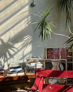 a red bench sitting in front of a window filled with books