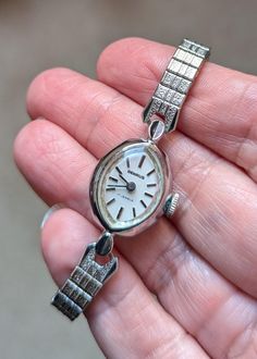 This is a beautiful Benrus white gold ladies watch that is currently working! I am not a watch expert, nor have I had it tested or serviced, it is being sold AS IS. I've wound it several times and it keeps fairly good time, not perfect, but ok.  I would strongly recommend having it serviced by a professional. The marquis shaped face has a pearly white face and silver hands and numerals. The watch screams MCM! This watch  would best fit a wrist 5.5" or smaller. The band is a stretch so easy, comfy fit! The watch is 10k RGP. Given the age of the watches there will be scuffs and scratches, I do my best to highlight them in the pics and detail them in the description so there are no unpleasant surprises after purchase! This one is really lovely!! This bracelet makes a statement and are perfect Whimsigoth Wedding, Stretch Band, Stretch Bands, White Face, Steampunk Fashion, Jewelry Cleaner, Ladies Watch, Comfy Fits, Body Oil