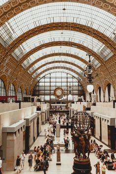 the inside of a train station with lots of people