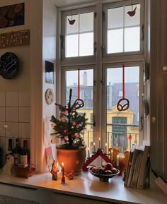 a small christmas tree sitting on top of a window sill