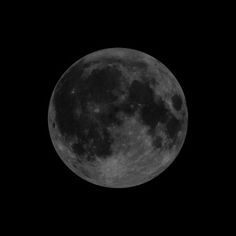 the full moon is shown in black and white