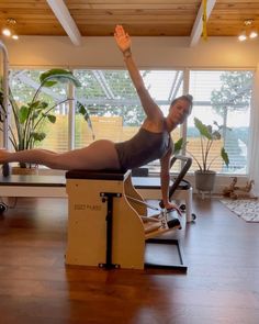 a woman is doing exercises on an exercise machine