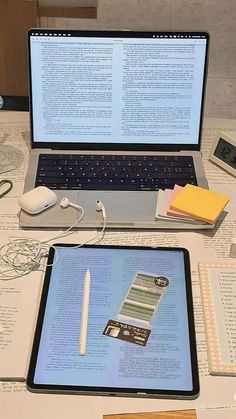 an open laptop computer sitting on top of a table next to a keyboard and mouse