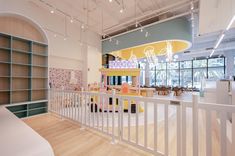 the inside of a children's playroom with toys and bookshelves on display