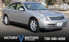 a silver car parked in a parking lot with the words victory motors written on it