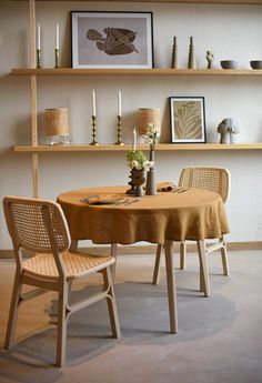 a dining room table with two chairs next to it