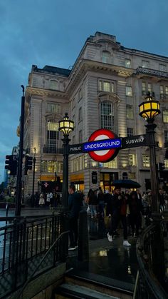 people are standing outside the underground subway station