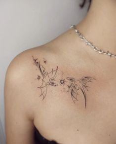 a woman with a tattoo on her shoulder is looking down at the viewer's chest