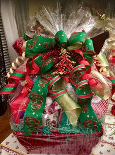 a basket filled with lots of different types of christmas ribbons and bows on top of a table