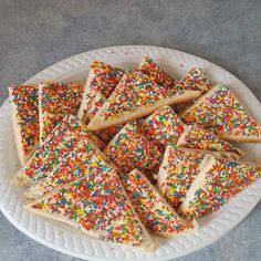 a white plate topped with lots of sprinkles on top of a table