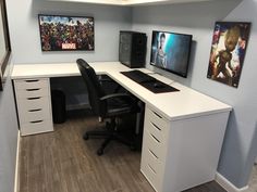 an office desk with two monitors and speakers on the wall, along with other items