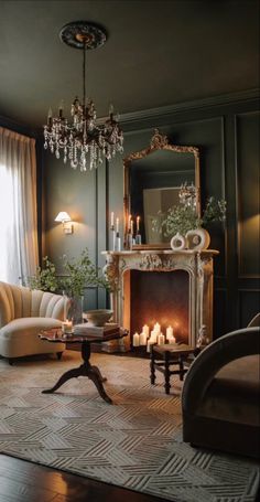 a living room filled with furniture and a chandelier hanging from the ceiling over a fire place