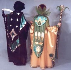 two figurines are dressed in costumes