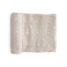 two pieces of linen with white stars on them, one is folded up and the other has