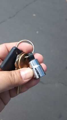 a person holding two keys in their hand