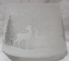 a frosted glass vase with an image of two deer